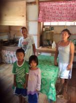 Generio and his wife Lin Lin and their two children in their new home