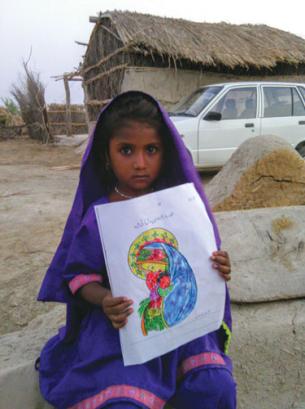A Parkari Kholi child displays her crayon drawing