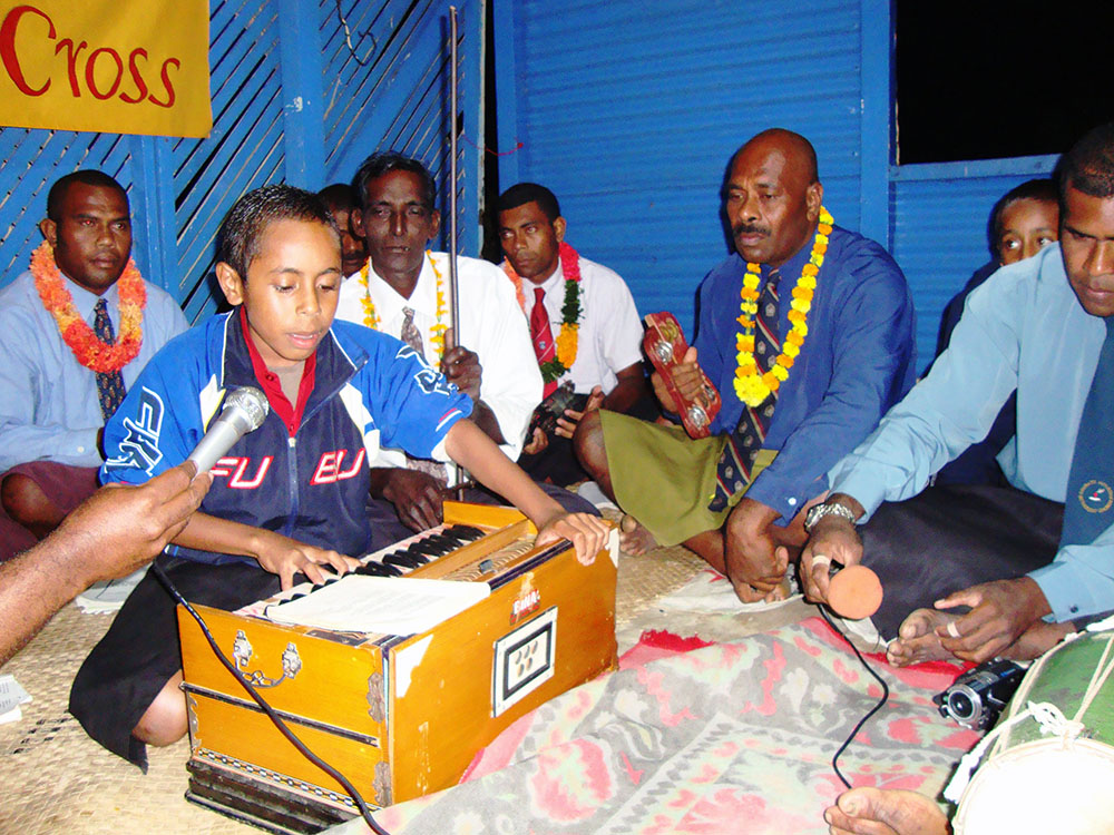 Boy playing Indian musical instrument. Photo: Columbans Fiji