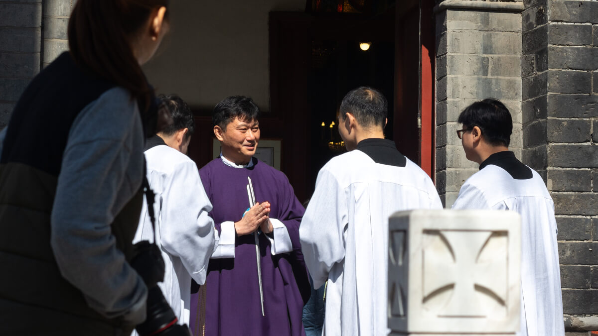 Chinese catholic priests at a catholic church in Beijing. Photo: Mirko Kuzmanovic / Shutterstock.com