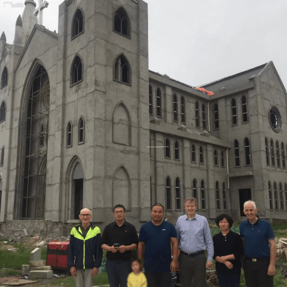 (Left to right): Ruairi, Fr Joseph, parish priest, Fr Kevin, parish sister, Fr Dan – outside one of the new churches in the Hanyang diocese. Photo: Kevin O'neill