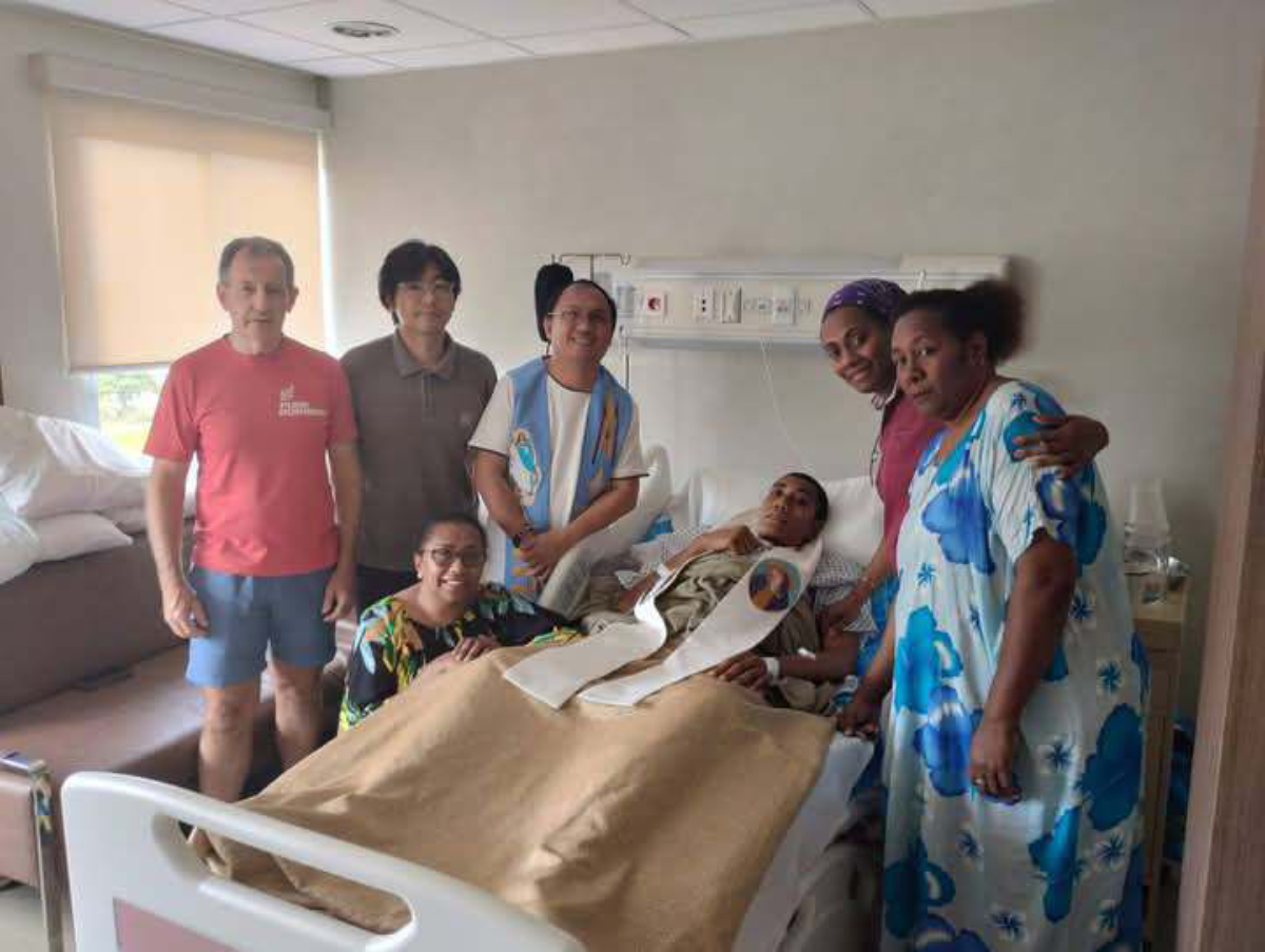 Fellow Columbans and family members visit Aminiasi in the hospital